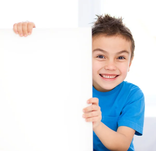 Cute boy is holding blank banner — Stock Photo, Image