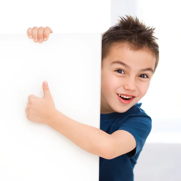 Cute boy is holding blank banner — Stock Photo, Image