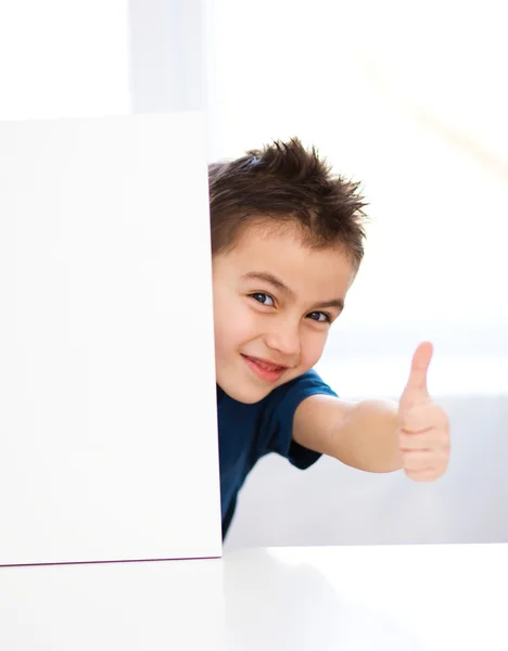 Cute boy is holding blank banner — Stock Photo, Image