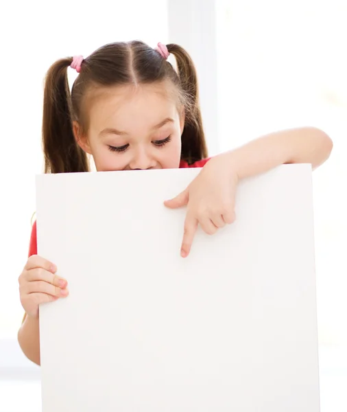 Cute girl is holding blank banner — Stock Photo, Image