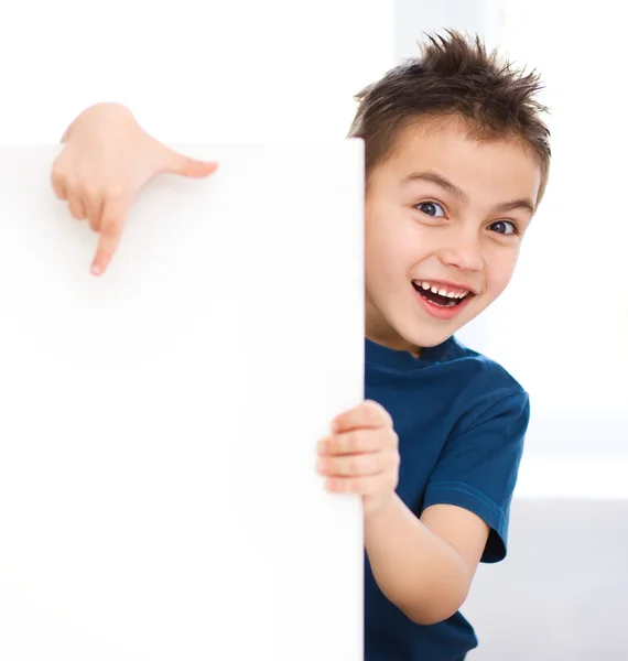 Cute boy is holding blank banner Royalty Free Stock Images