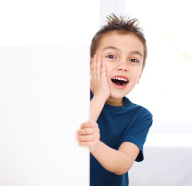 Cute boy is holding blank banner clipart