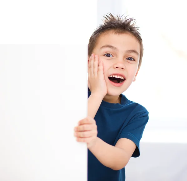 Cute boy is holding blank banner — Stock Photo, Image