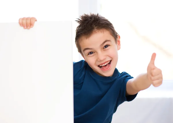 Cute boy is holding blank banner — Stock Photo, Image