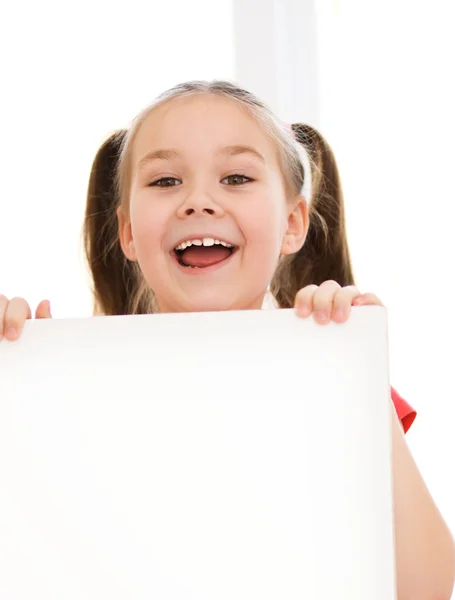 Cute girl is holding blank banner — Stock Photo, Image