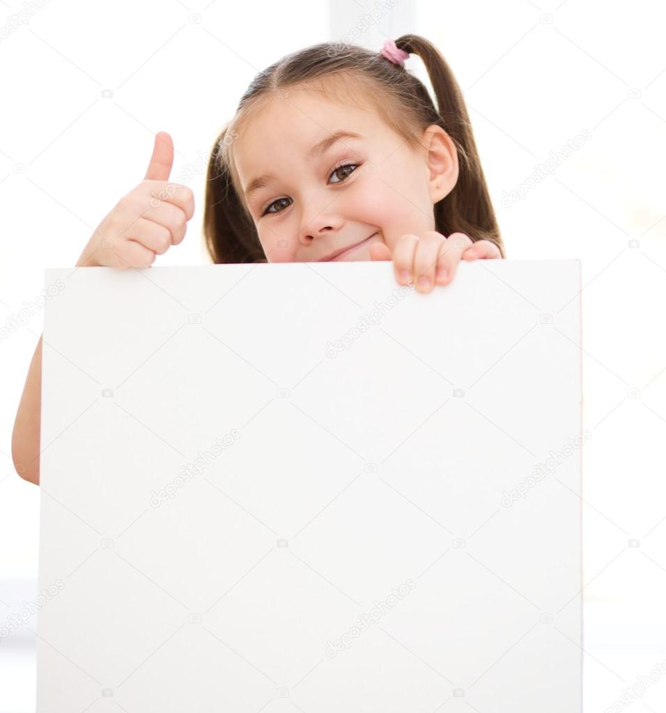 Cute girl is holding blank banner