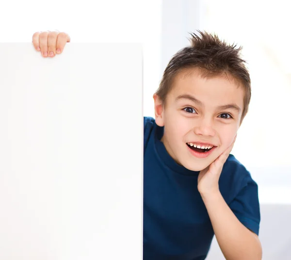 Cute boy is holding blank banner — Stock Photo, Image