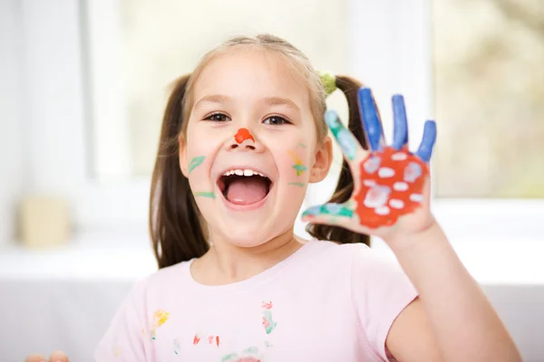 Portrait of a cute girl playing with paints — Stock Photo, Image