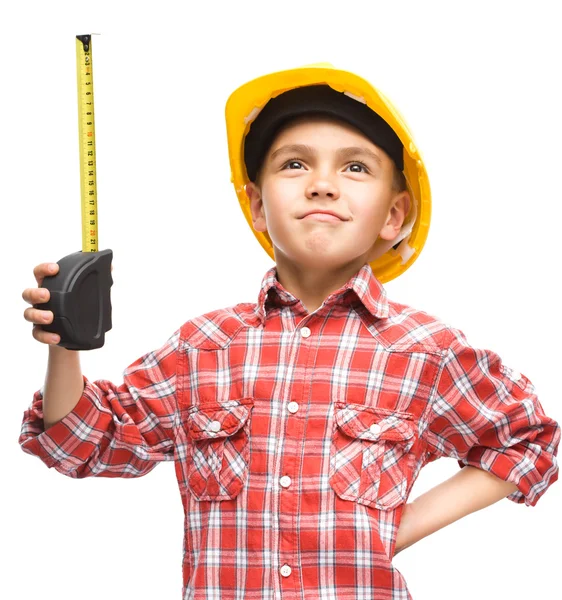Boy as a construction worker with tape measure — Stock Photo, Image