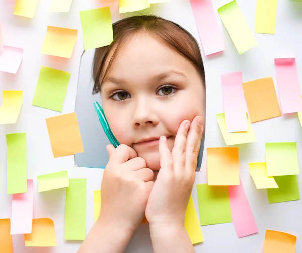 Cute girl with lots of reminder notes — Stock Photo, Image