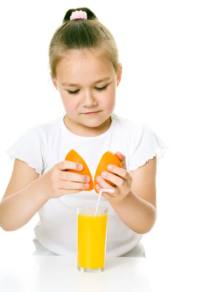 Cute girl is drinking orange juice — Stock Photo, Image