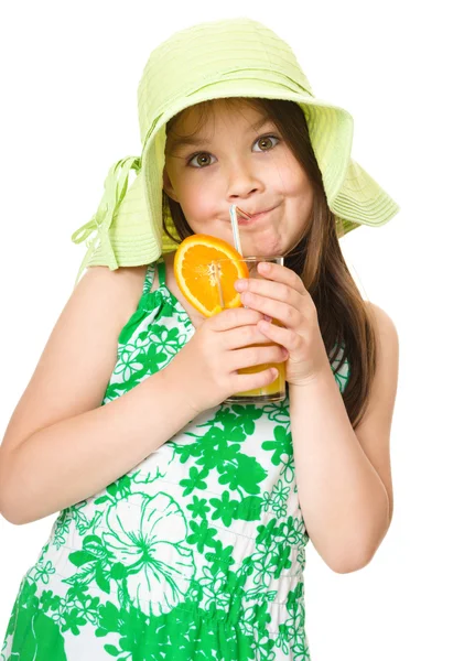 Cute girl is drinking orange juice — Stock Photo, Image