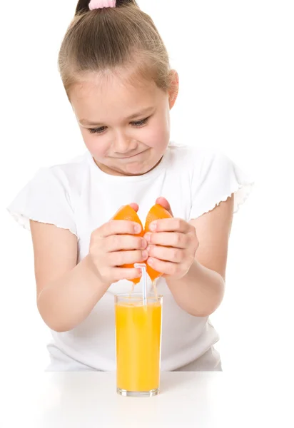 Cute girl is drinking orange juice — Stock Photo, Image