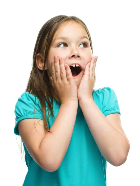 Cute girl is holding her face in astonishment — Stock Photo, Image