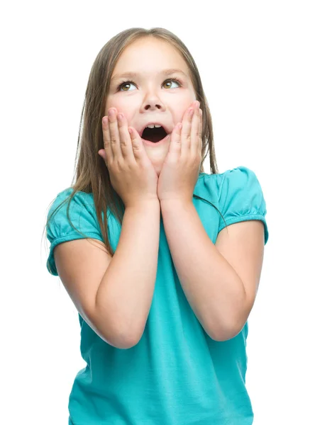 Cute girl is holding her face in astonishment — Stock Photo, Image