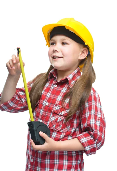 Menina como um trabalhador da construção civil com fita métrica — Fotografia de Stock