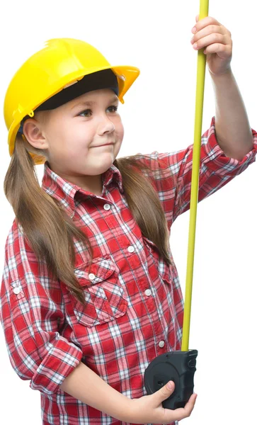 Girl as a construction worker with tape measure — Stock Photo, Image