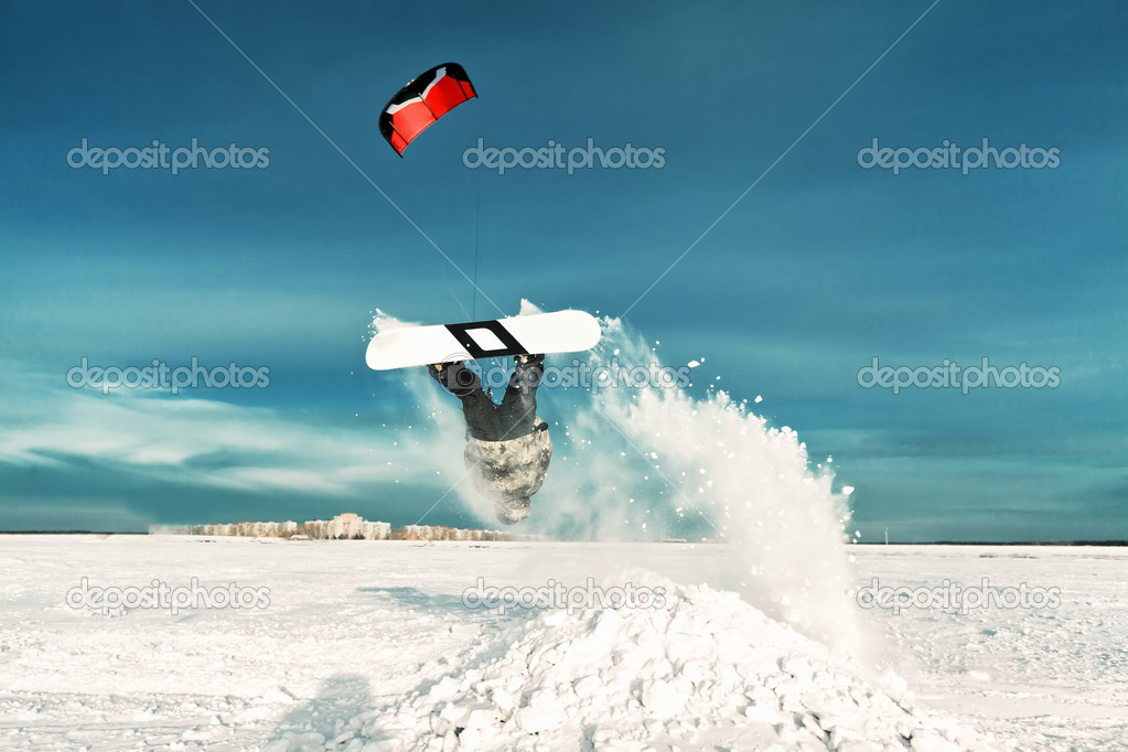 kiting on a snowboard on a frozen lake