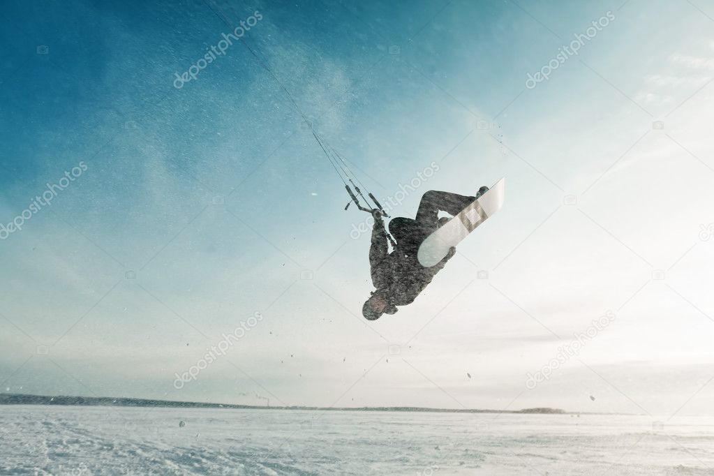 kiting on a snowboard on a frozen lake