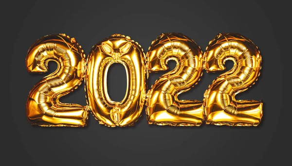 Bonne année 2022 célébration. Des ballons dorés brillants représentent des ballons du Nouvel An avec des étoiles scintillantes sur fond sombre. Noël et Nouvel An. Ballons en feuille d'or numéral 2022 et confettis — Photo
