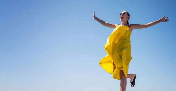 Happy Woman Yellow Dress Jumping Laughing Blue Sky Lot Copy — Stock Photo, Image