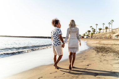 Romantik mutlu çift sahilde yaz yürüyüşünün tadını çıkarıyor. Turist. Seyahat et. Tatil