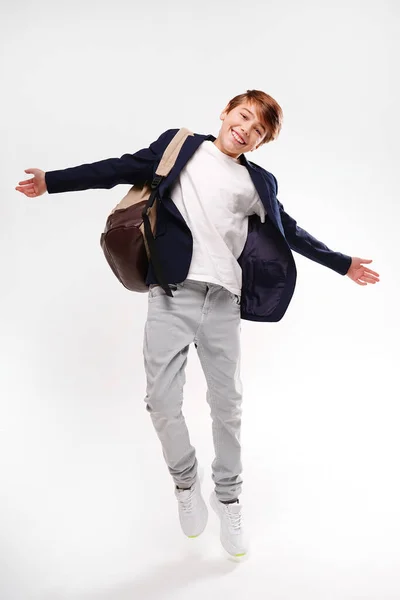 Young Energetic Handsome Happy School Boy Fashionable Clothes Jumping Backpack — Stockfoto