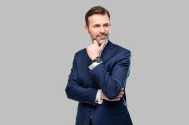 Stüdyoda poz veren şık takım elbiseli yakışıklı iş adamı kameraya bakıyor. Portre. Uzayı kopyala Sakallı adam.