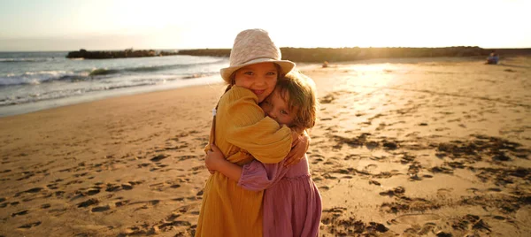 Happy Little Cute Girls Enjoying Sunny Day Beach Hugging Smiling — стоковое фото
