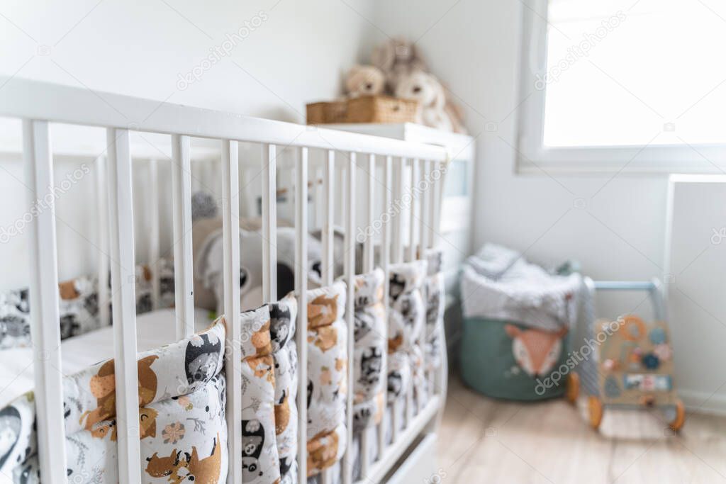 Modern baby room interior with stylish furniture and beautiful toys. Real photography