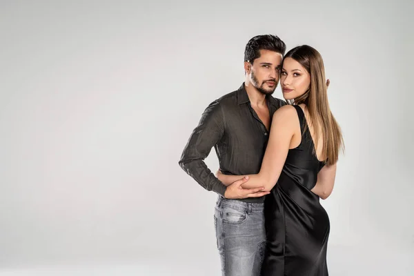 Photo of beautiful , elegant couple. Handsome man posing with attractive woman. Love.Date. Valentines day. A lot of copy space on the grey light studio background