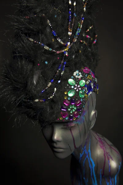 Painted mannequin girl with decorative headwear — Stock Photo, Image