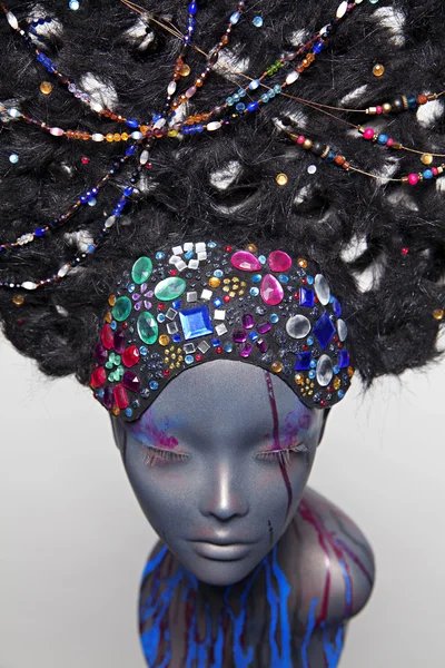 Painted mannequin girl with decorative headwear — Stock Photo, Image