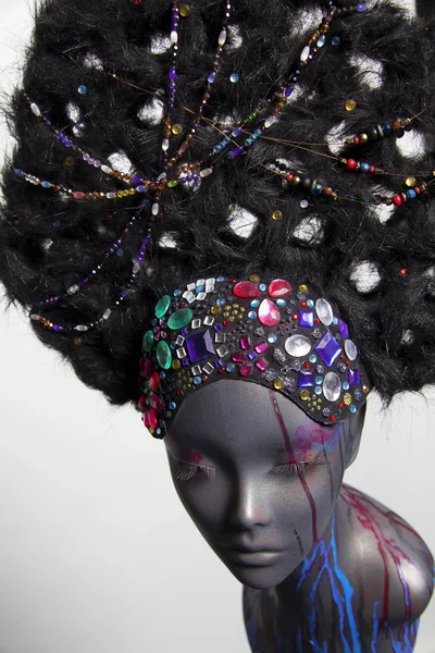 Painted mannequin girl with decorative headwear — Stock Photo, Image