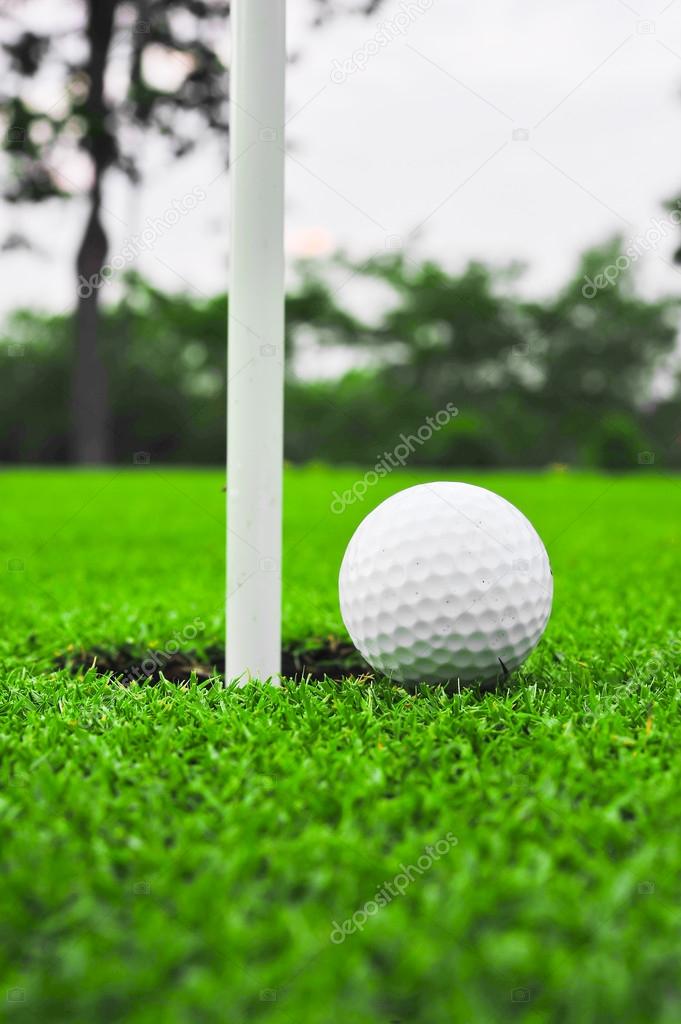 golf ball on lip of cup 