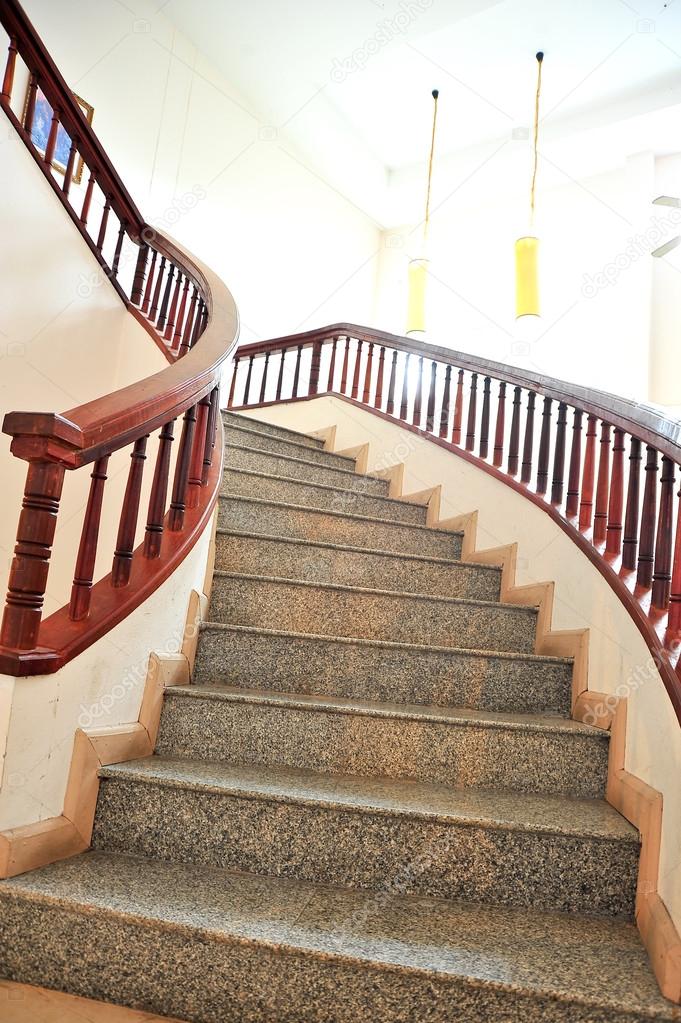 Marble stairs with wooden railing 