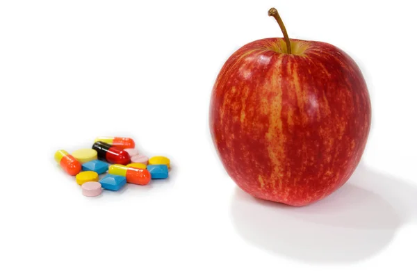 Red apple and pills. — Stock Photo, Image