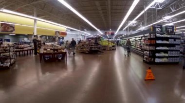 Augusta, Ga USA - 01 02 22: Walmart retail interior people wearing face masks pushing shopping carts
