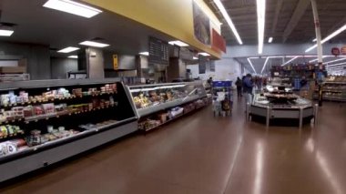 Augusta, Ga USA - 01 02 22: Walmart retail interior worker wearing face masks in deli area