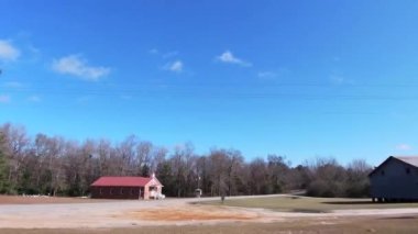 Vidette, Ga USA - 01 02 22: Small town USA large industrial silver metal silo containers with a beautiful blue sky and clouds background