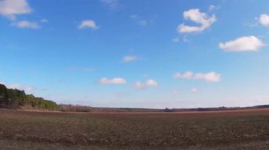 Pan of rural farmland that has been freshly plowed dirt rows in southern Georgia 