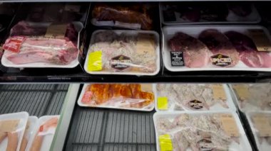 Hephzibah, Ga USA - 01 14 22: KJs Retail grocery store Supply chain and staffing issues tilt of fresh packaged seasoned meats