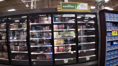Grovetown, Ga USA - 01 15 22: Georgia snow scare Kroger retail grocery store hard shopped frozen section and lady wearing a face mask