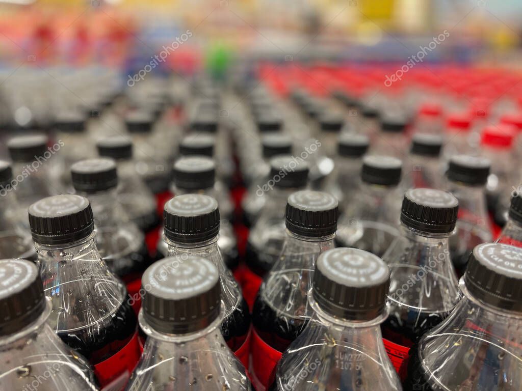 Grovetown, Ga USA - 03 05 22: Retail soda tops blurred bokeh colorful background