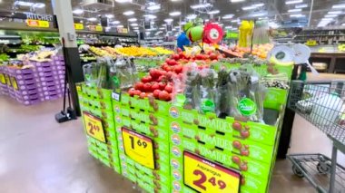 Grovetown, Ga USA - 05 13 22: Kroger retail store people in produce tomato display 
