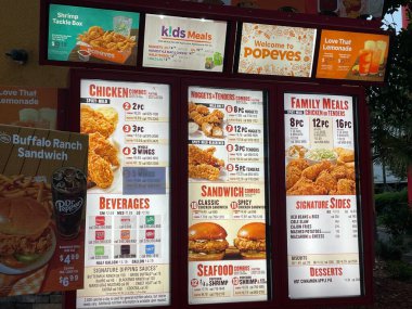 Grovetown, Ga USA - 05 10 22: Popeyes fried chicken restaurant drive thru menu close up