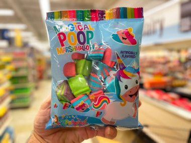 Grovetown, Ga USA - 07 24 22: Retail grocery store hand holding Magical Poop candy