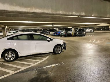 Augusta, Ga USA - 12 14 21: Hospital parking garage deck wrecked front corner of a white car