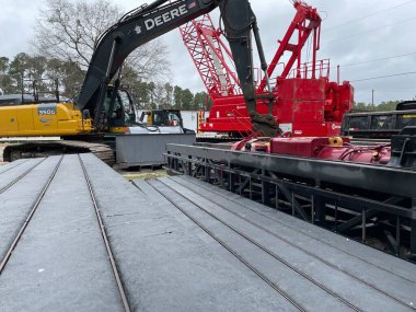 Augusta, Ga USA - 03 19 22: CAT heavy construction machinery John deere and red crane