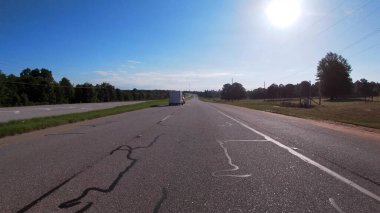 Augusta, Ga USA 05 15 21: POV driving on a rural country highway with the sun beaming
